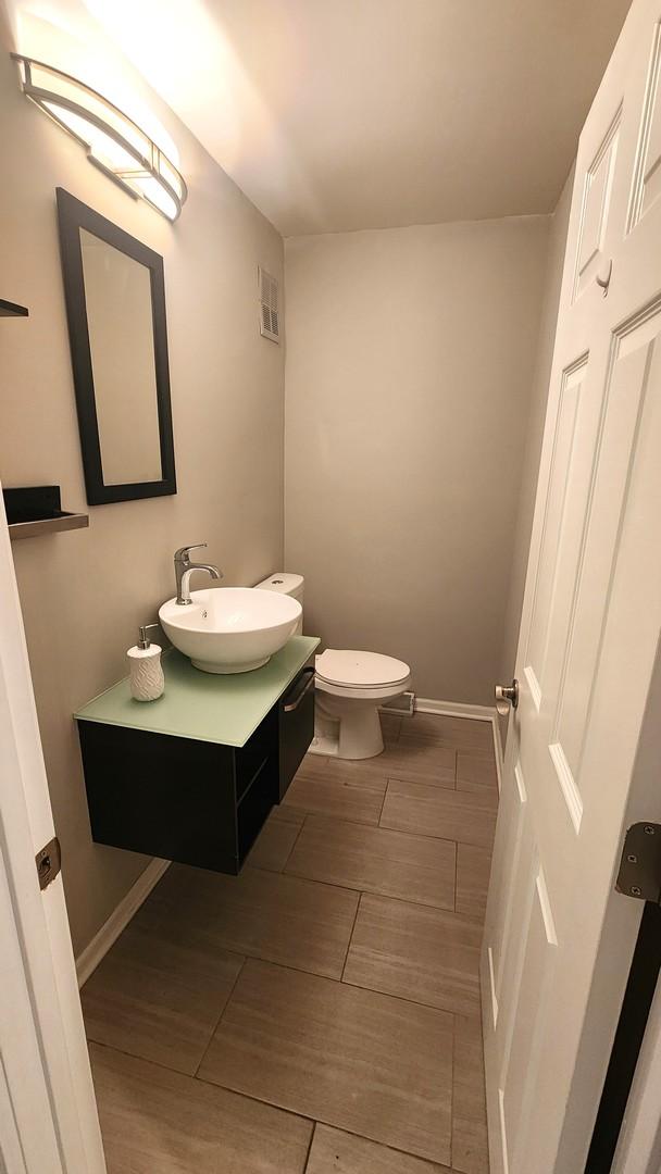 bathroom featuring vanity and toilet