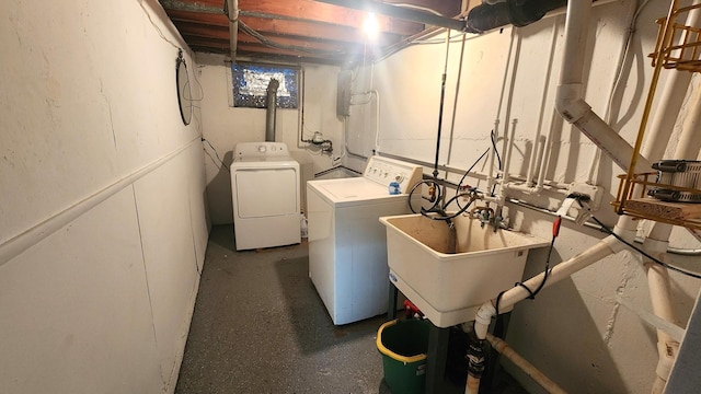 washroom with sink and separate washer and dryer