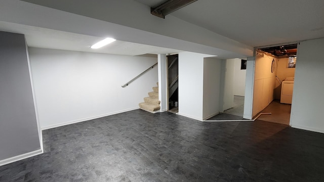 basement featuring washer / dryer and dark hardwood / wood-style floors