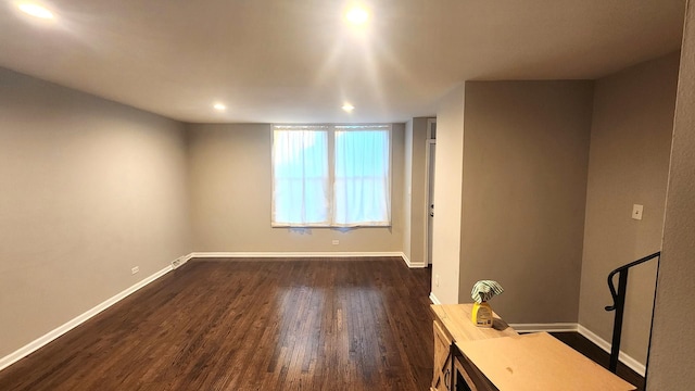 unfurnished room featuring dark hardwood / wood-style flooring