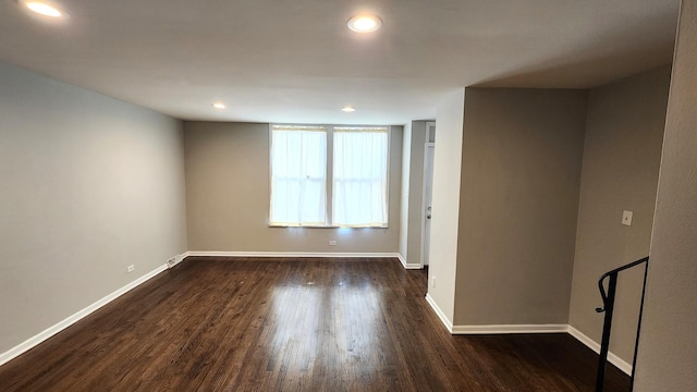 empty room with dark hardwood / wood-style flooring