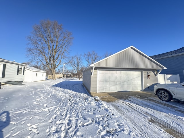 exterior space with a garage and an outbuilding