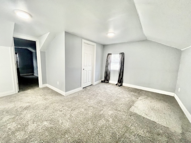 bonus room featuring vaulted ceiling and carpet floors