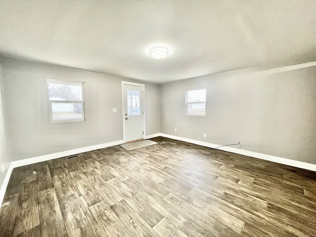 unfurnished room with hardwood / wood-style floors