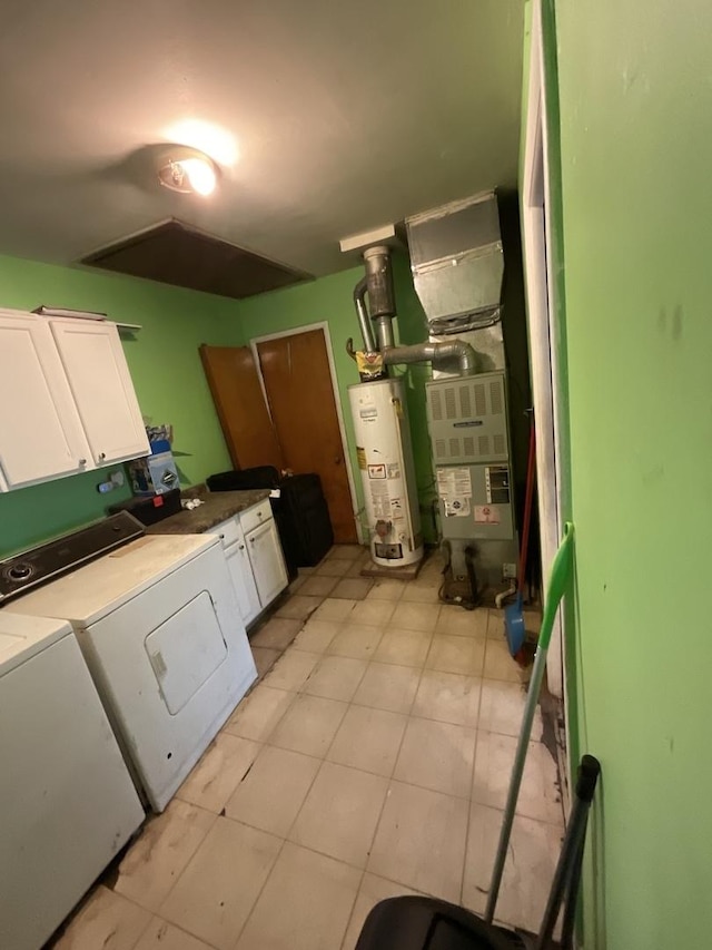 kitchen featuring heating unit, white cabinetry, gas water heater, and independent washer and dryer