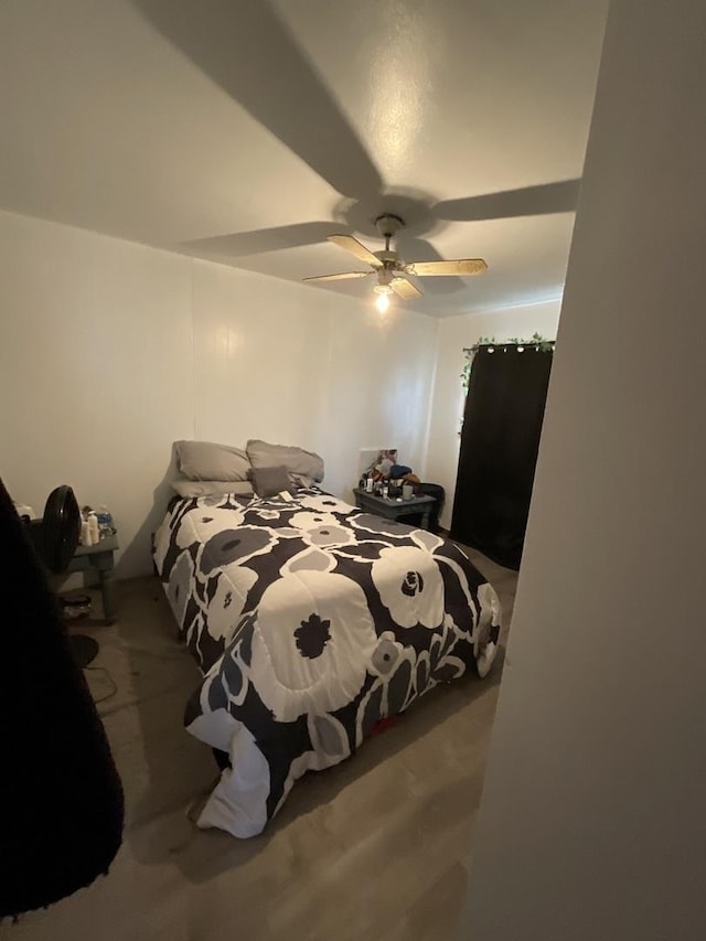 bedroom with wood-type flooring and ceiling fan