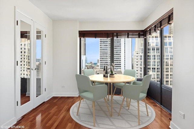 dining space with french doors and dark hardwood / wood-style floors