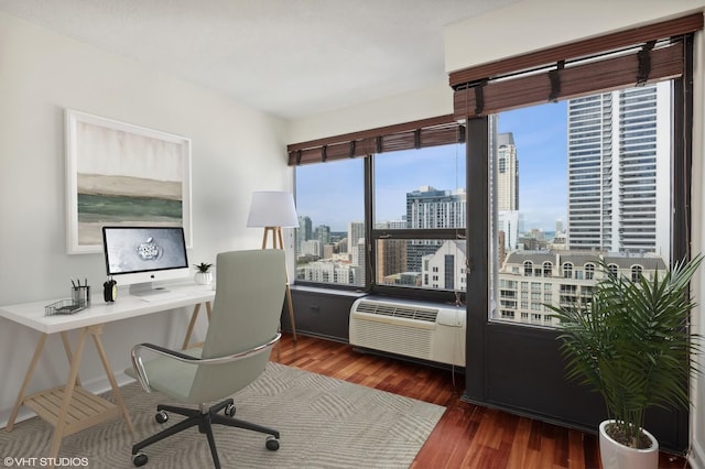 office space with an AC wall unit and dark wood-type flooring