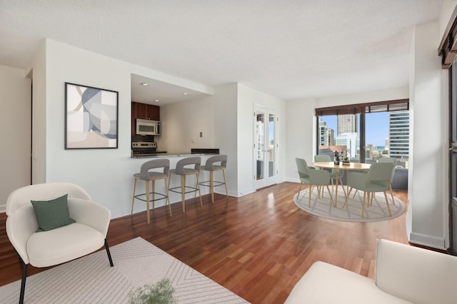 living room featuring french doors and hardwood / wood-style flooring