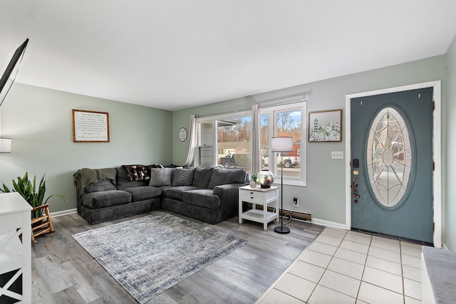 living room featuring light wood-type flooring and a baseboard radiator