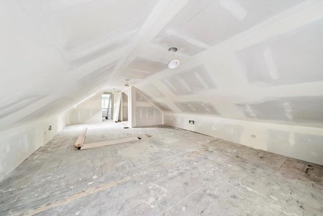 additional living space featuring lofted ceiling