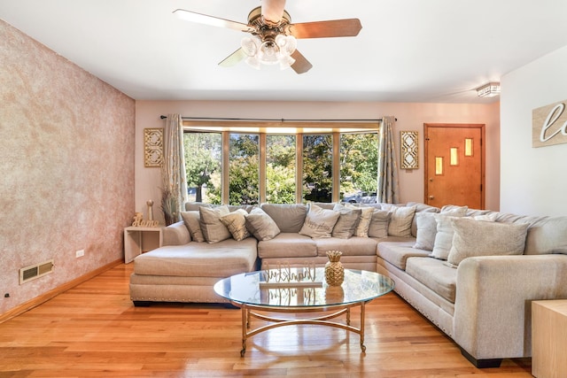 living room featuring ceiling fan and light hardwood / wood-style flooring