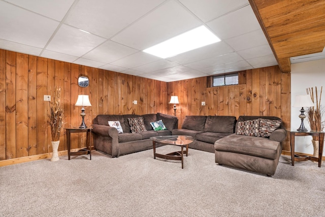 living room with carpet flooring and a paneled ceiling