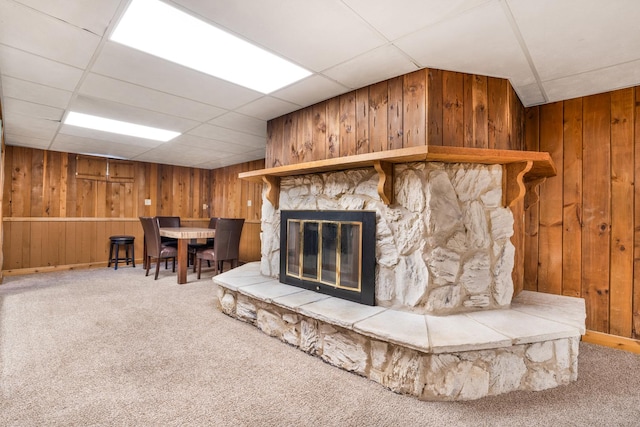 interior space with a fireplace and a drop ceiling