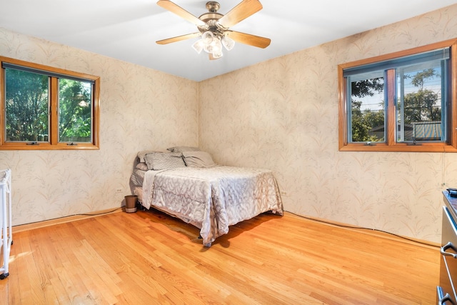 bedroom with ceiling fan and wood-type flooring