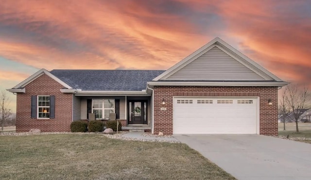 ranch-style house with a garage and a lawn