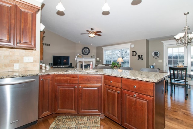 kitchen with decorative light fixtures, dishwasher, sink, and a wealth of natural light