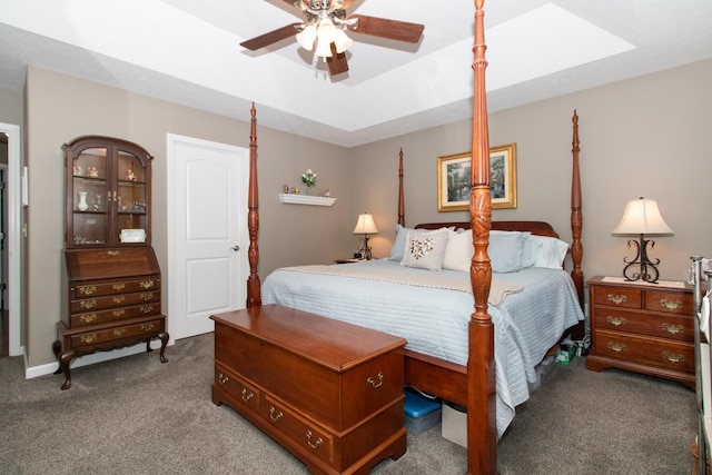 bedroom with ceiling fan, a raised ceiling, and carpet