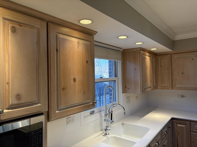 kitchen featuring sink and crown molding