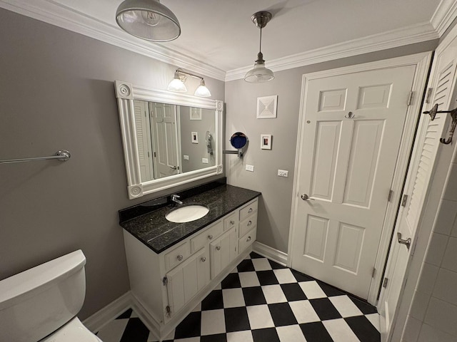 bathroom featuring vanity, toilet, and ornamental molding