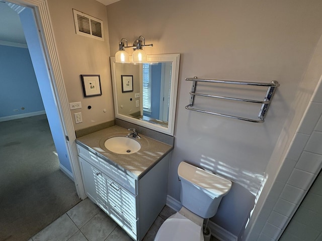 bathroom with tile patterned floors, vanity, ornamental molding, and toilet