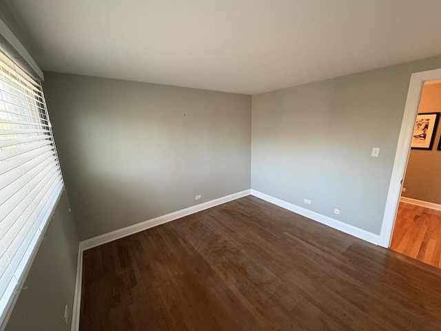 spare room with dark hardwood / wood-style floors