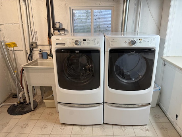 clothes washing area with light tile patterned floors and washing machine and clothes dryer