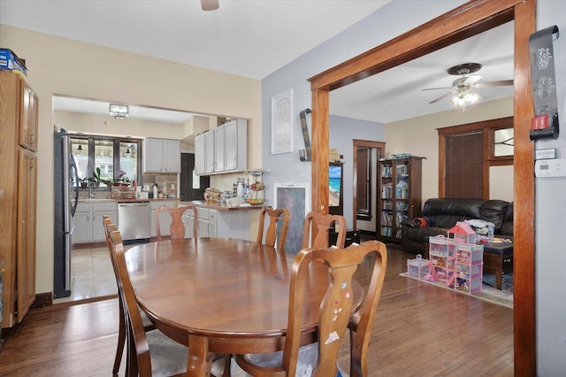 dining space with ceiling fan and light hardwood / wood-style floors