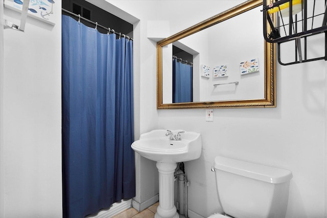 bathroom featuring toilet and tile patterned floors