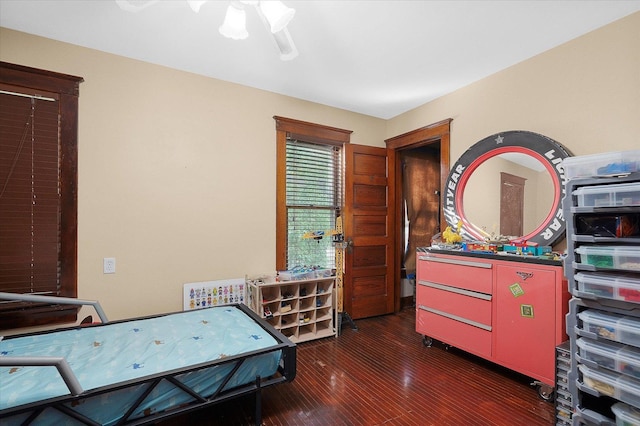 bedroom featuring dark wood-type flooring and ceiling fan