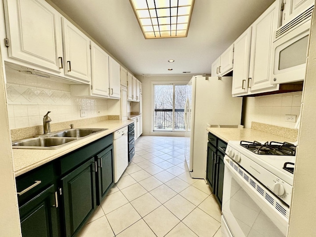 kitchen featuring white cabinetry, white appliances, sink, and light tile patterned floors