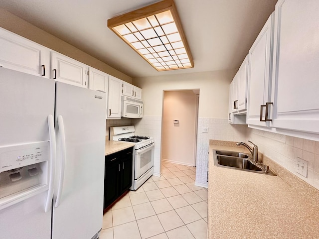 kitchen with backsplash, sink, white cabinets, and white appliances