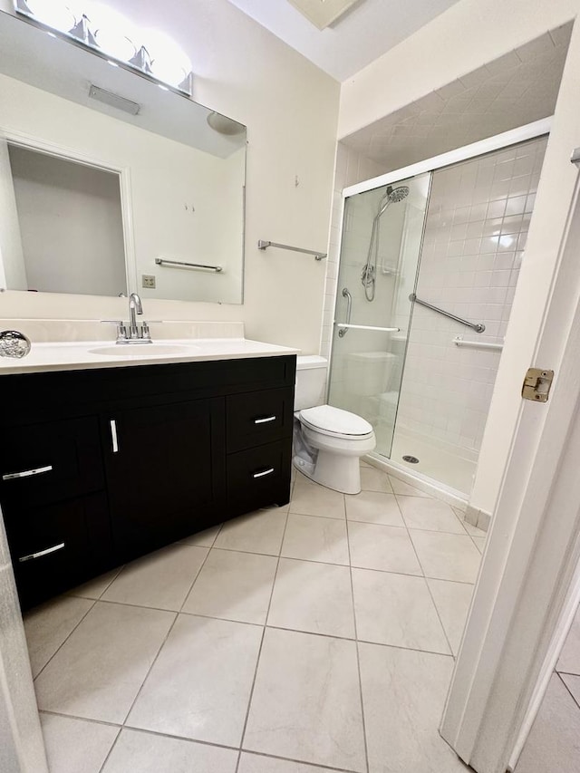 bathroom featuring walk in shower, tile patterned flooring, vanity, and toilet