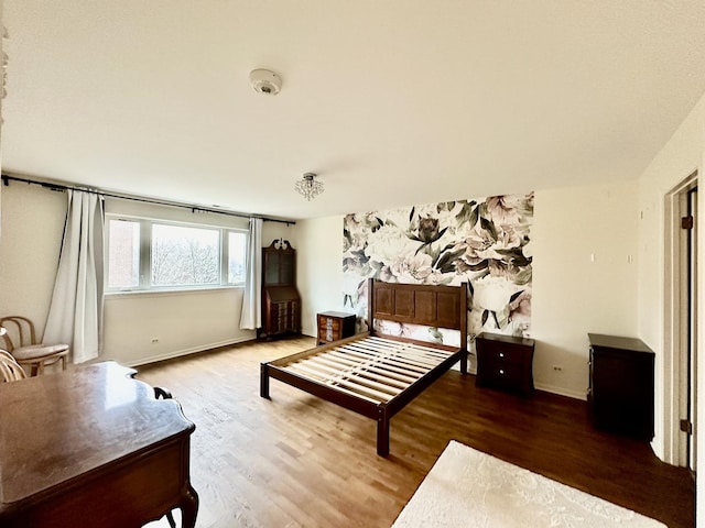 bedroom with hardwood / wood-style flooring