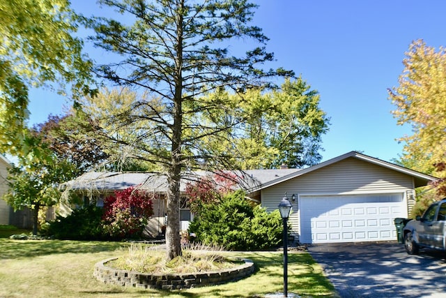 single story home featuring a front yard and a garage