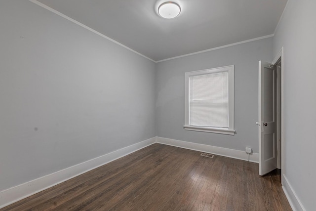 unfurnished room featuring dark hardwood / wood-style floors and ornamental molding