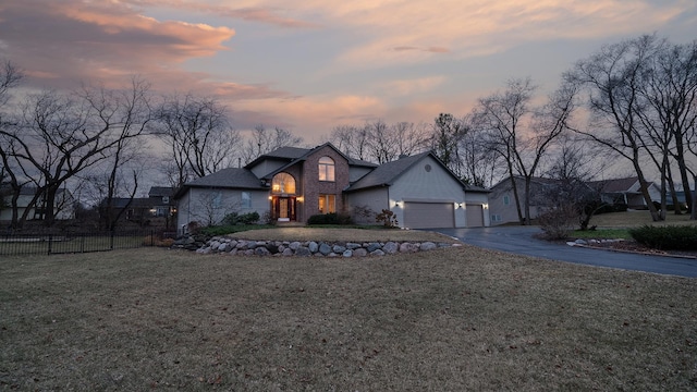 view of front of home with a lawn and a garage