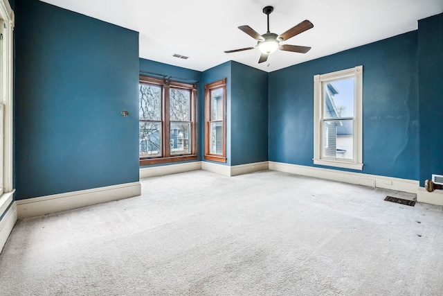 carpeted empty room featuring ceiling fan