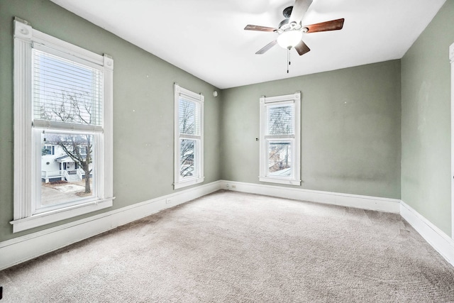 empty room with carpet flooring and ceiling fan