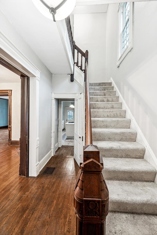 staircase featuring hardwood / wood-style flooring