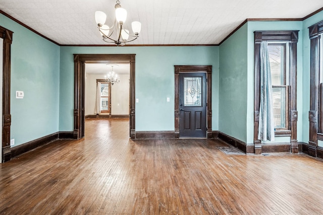 entryway with a notable chandelier, plenty of natural light, and hardwood / wood-style floors