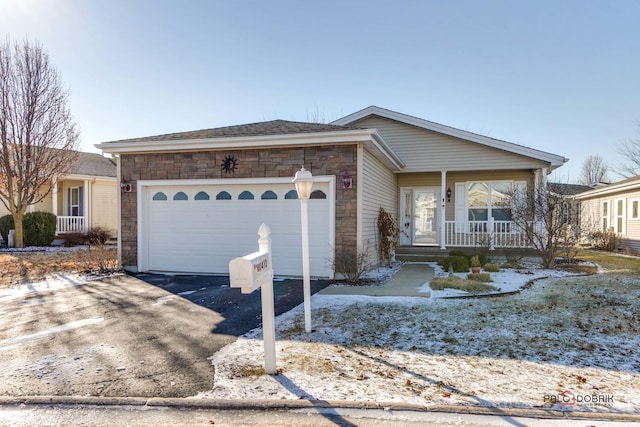 ranch-style home with covered porch and a garage