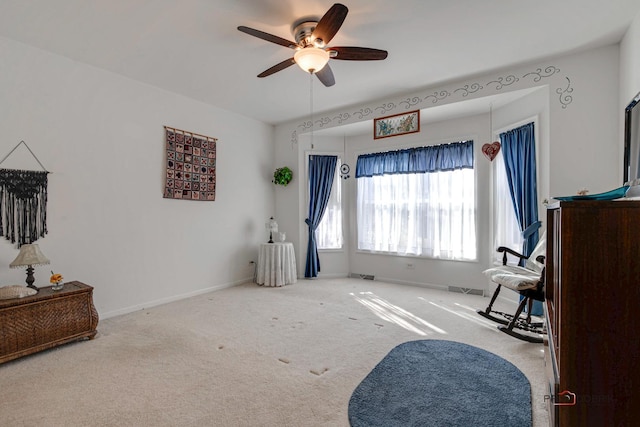 interior space featuring ceiling fan and carpet