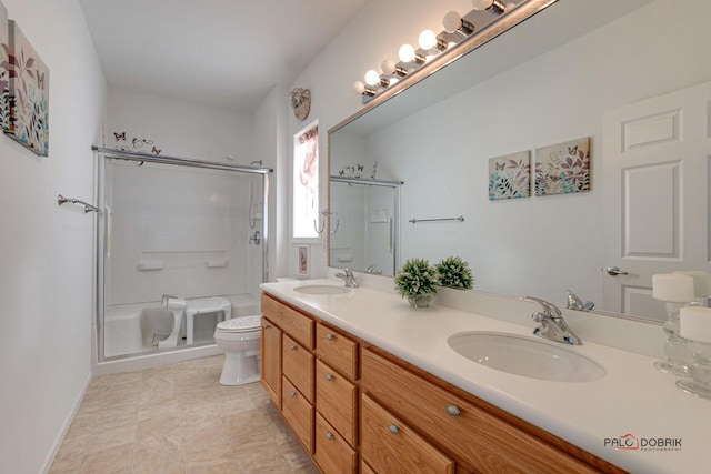 bathroom with vanity, a shower with shower door, and toilet