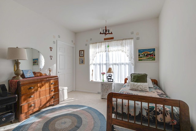 carpeted bedroom with a notable chandelier