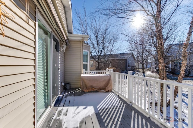 view of snow covered back of property