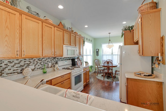 kitchen with light brown cabinets, white appliances, backsplash, dark hardwood / wood-style flooring, and pendant lighting