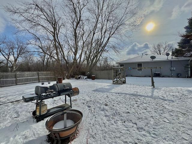 snowy yard with central AC