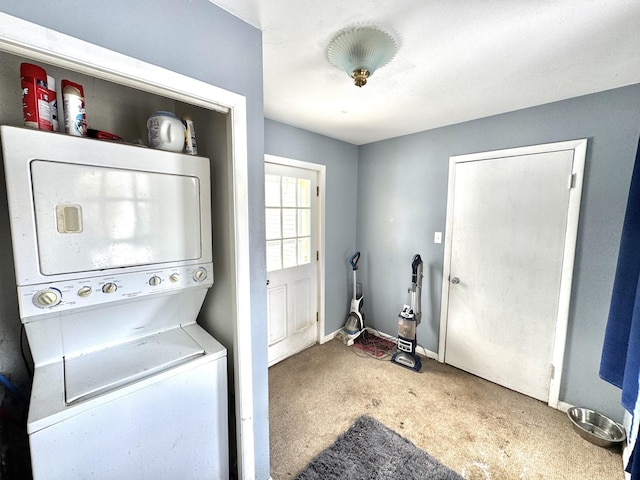 washroom with carpet floors and stacked washer and dryer