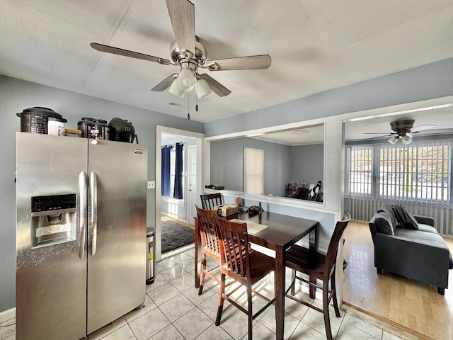 tiled dining area with ceiling fan